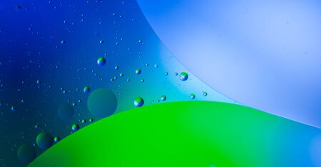 Abstract blue and green background with beautiful bubbles. Oil on the water.の写真素材