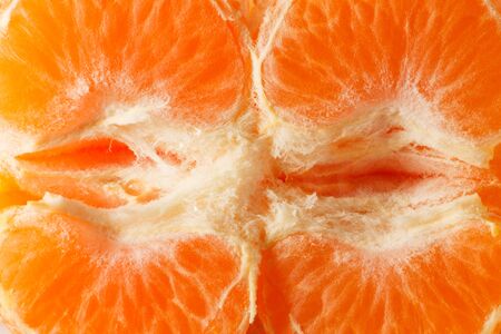 photo of ripe orange juicy ripe mandarin slices close-up