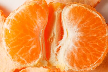 photo of ripe orange juicy ripe mandarin slices close-upの写真素材