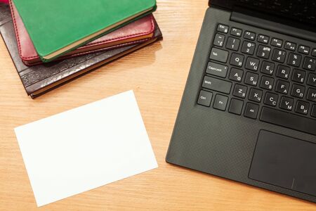 open laptop and note on office wooden table