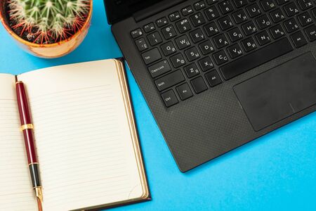 open diary with pen and laptop on a blue background
の写真素材