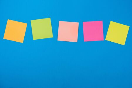 colored stickers for notes on a blue background