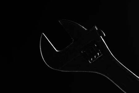 adjustable wrench silhouette on a black backgroundの写真素材