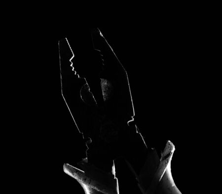 silhouette of pliers on a black backgroundの写真素材