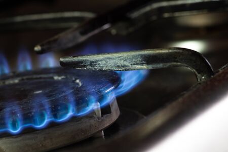 blue gas flame on a gas stove close-up