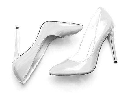 beautiful female shiny white stilettos on a white backgroundの写真素材