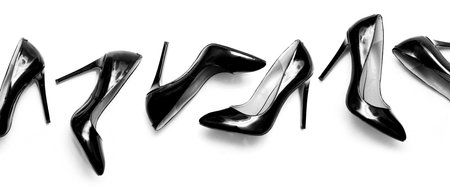 beautiful female shiny black stilettos on a white backgroundの写真素材