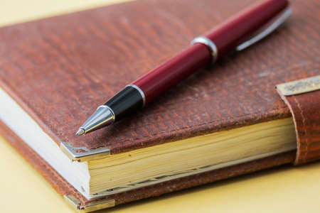 ballpoint pen lies on a notebook close-upの写真素材