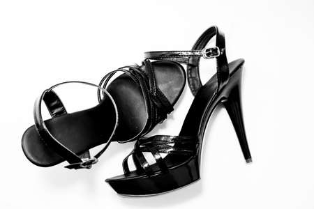 beautiful womens shiny patent black stiletto sandals on a white backgroundの写真素材