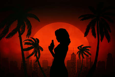 beautiful silhouette of a woman with a revolver against the background of the evening sun, city and palm treesの写真素材