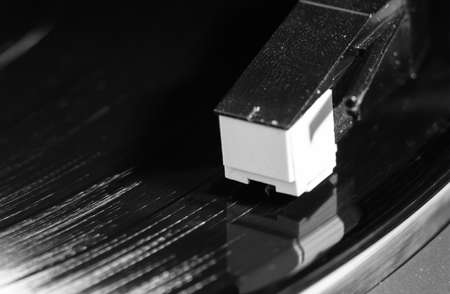 vinyl turntable needle on black record close upの写真素材