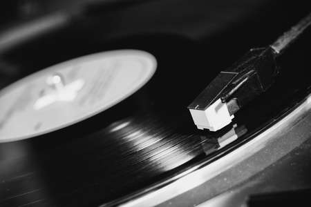 vinyl turntable needle on black record close upの写真素材