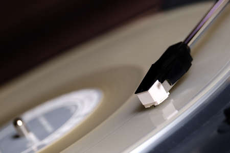 vinyl turntable needle on white record close up
