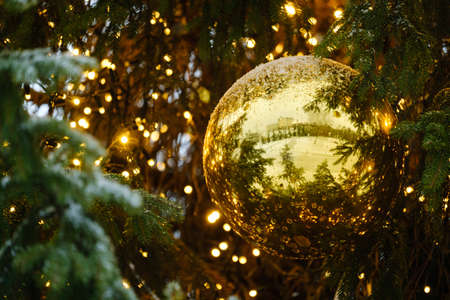 beautiful golden balls on christmas tree with glowing garland