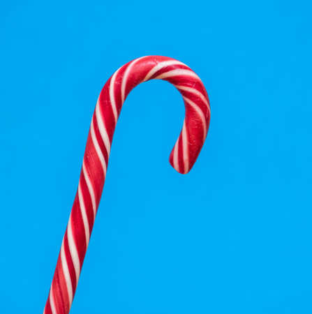beautiful candy lollipop cane on blue background