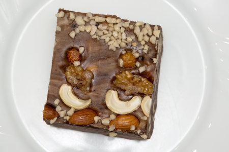 chocolate sherbet with nuts on a white plate close-upの写真素材
