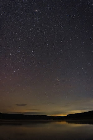 beautiful starry sky over the lake on a summer night in August
