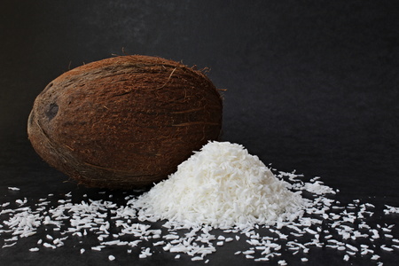 The image of the coconut on black with crunches.の写真素材
