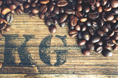 Beans coffe with wooden texture. Raw coffe with symbol weight in grams.の写真素材