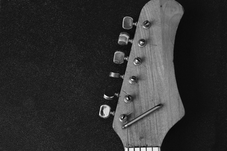 Wodenn neck of eletric guitar on the black backround.の写真素材