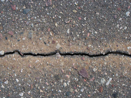 Long crack in asphalt road.の写真素材