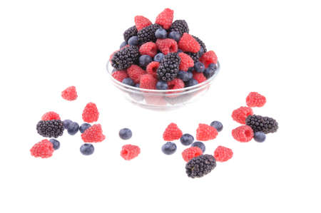 Pot of raspberries, blueberries and blackberries on a white background