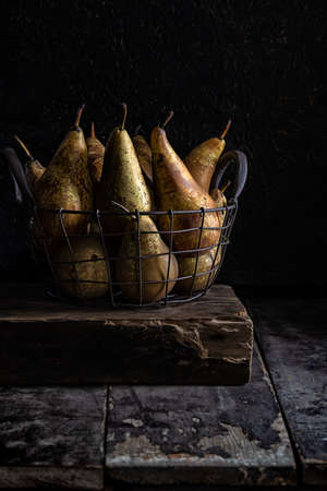 Basket of pears on an old tableの写真素材