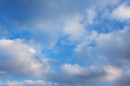 blue sky background with white clouds at sunsetの写真素材