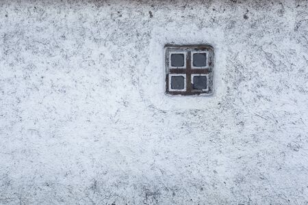 Old window on the background of clay walls. Textureの写真素材