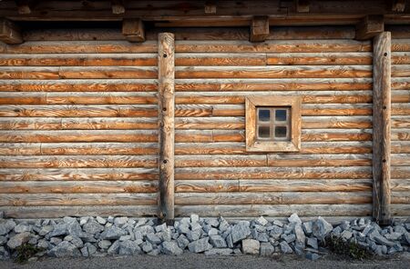 Old window of the old wooden house on the background of wooden wallsの写真素材