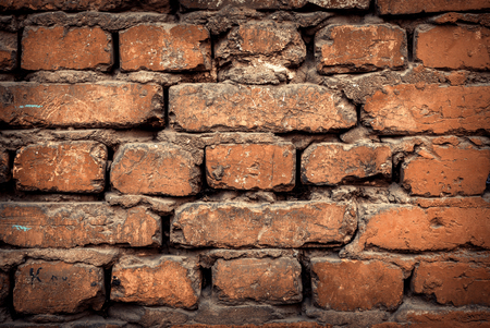 Background of colorful brick wall texture. brickwork. Peeling paint. Pattern of rustic grunge material.の写真素材