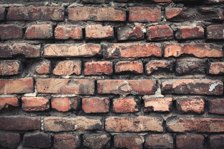 Background of colorful brick wall texture. brickwork. Peeling paint. Pattern of rustic grunge material.の写真素材