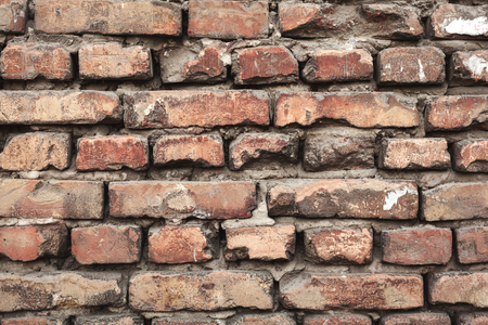 Background of colorful brick wall texture. brickwork. Peeling paint. Pattern of rustic grunge material.の写真素材