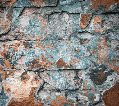 Background of colorful brick wall texture. brickwork. Peeling paint. Pattern of rustic grunge material.の写真素材