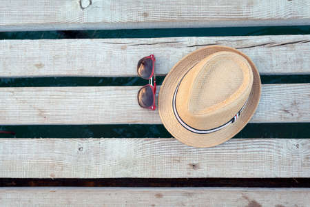 Sunglasses and hat on the wooden texture in summer.の写真素材