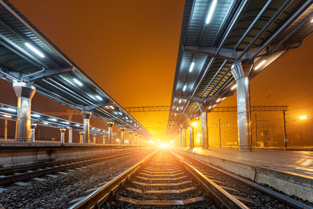 Railway station at night. Train platform in fog. Railroad in Donetskの写真素材