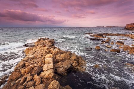 Sea waves with rocks on the beach at sunset. Beatuful landscapeの写真素材