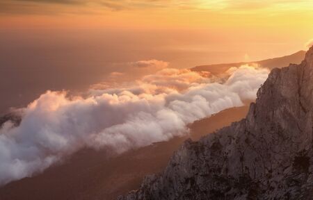 Beautiful landscape on the top of mountains with low clouds at sunset. Nature backgroundの写真素材