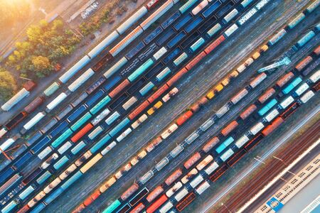 Top view of colorful cargo trains. Aerial view from flying drone of colorful freight trains on the...