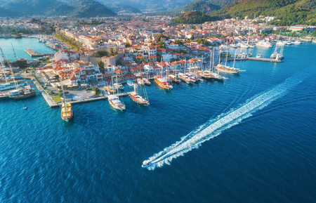 Aerial view of boats, yahts, floating ship and beautiful architecture at sunset in Marmaris, Turkey. Landscape with boats in marina bay, blue sea, city. Top view of harbor with yacht and sailboat. の写真素材