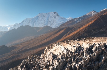 Beautiful view of snow-covered mountain against blue sky at sunrise in Nepal. Landscape with snowy peaks of Himalayan mountains, glacier, rocks, hills in the morning. Amazing Himalayas. Natureの写真素材