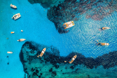 Aerial view of boats and luxury yachts in transparent blue sea at sunny day in Spain. Colorful landscape with marina bay, azure water. Balearic islands. Top view. Travel in Europe. Summer vacationの写真素材