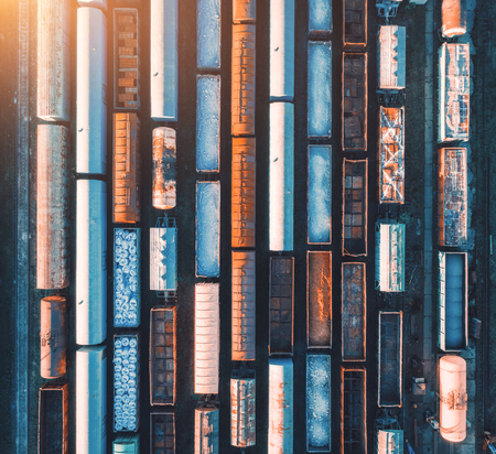 Aerial view of railway wagons. Cargo trains. Top view of colorful freight train on the railway station. Wagons with goods on railroad. Heavy industry. Industrial conceptual landscape. Transportationの写真素材
