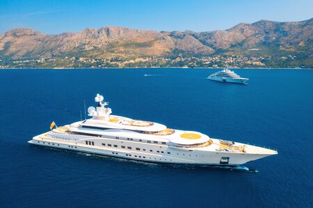 Aerial view of luxury yacht and blue sea at sunny bright day in summer. Big white modern boat. Top...