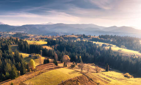 Aerial view of beautiful village in mountains at sunsetの写真素材