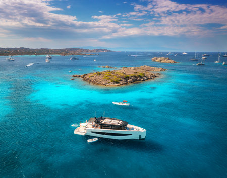Luxury yacht on blue sea and small island at sunny day in summerの写真素材