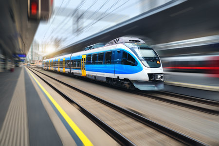 High speed train in motion on the railway station at sunsetの写真素材