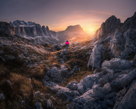Woman on the mountain trail and stones at sunset in autumnの写真素材