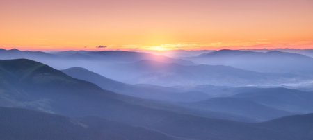 Amazing silhouettes of a mountains at colorful sunset in summerの写真素材