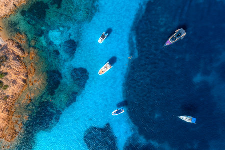 Aerial view of luxury yachts and boats on blue sea at sunny dayの写真素材